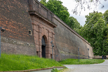 city wall with tunnel and walking path and trees
