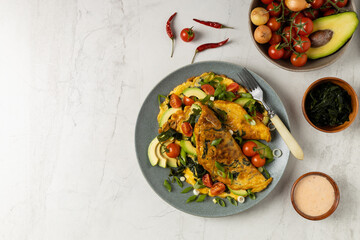 Pancakes with seaweed. Served on a plate with avocado and tomatoes.