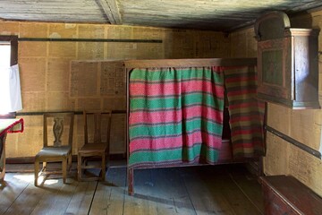 Obraz na płótnie Canvas Vintage room with bed, cupboard and chairs in old rural house, Seurasaari Open-Air Museum, Helsinki, Finland.