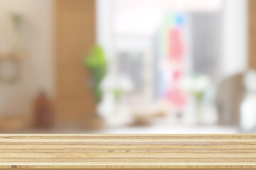 Wooden table top on blurred light window background