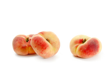 Three saturn peaches or flat peaches isolated on white background with clipping path..