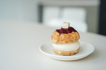 Close up scone on a white plate on white table in copy space concept.