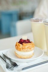 Close up scone on a white plate with cup of hot coffee on white table at cafe.