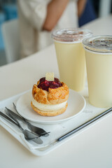 Close up scone on a white plate with cup of hot coffee on white table at cafe.