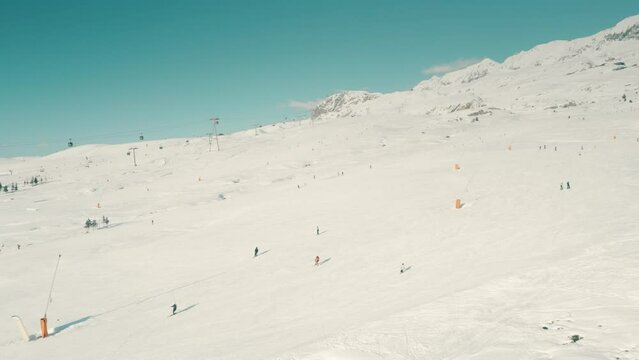 Aerial shot of Alpine ski slope, high season. Alps, France