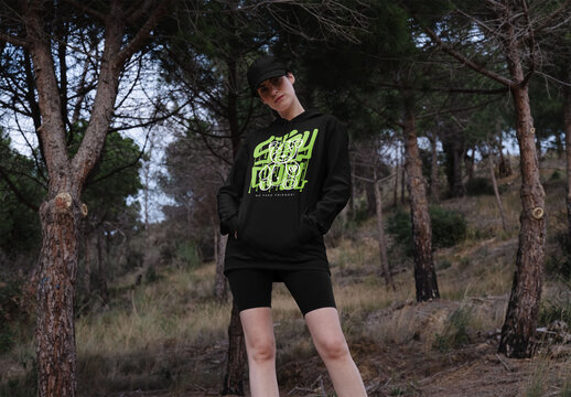 Mockup of woman wearing customized hoodie by trees
