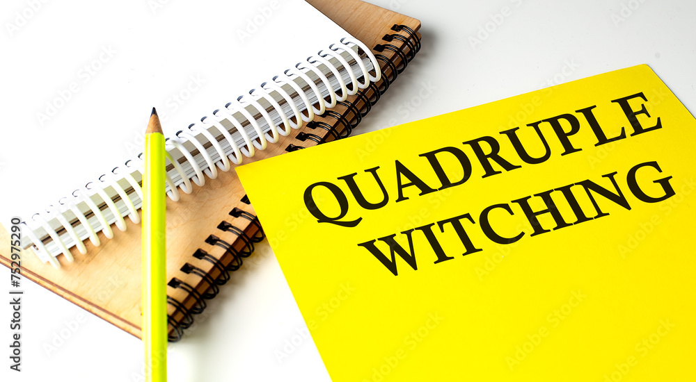 Poster quadruple witching text written on a yellow paper with notebook