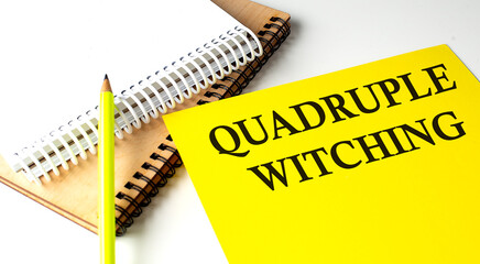 Quadruple Witching text written on a yellow paper with notebook