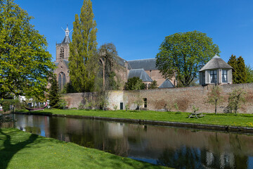 Fototapeta na wymiar Vianen in the Netherlands. 30 April 2023. Vianen cityscape with canal, church and the old city wall. Vianen is a city and a former municipality in the central Netherlands, in the province of Utrecht.