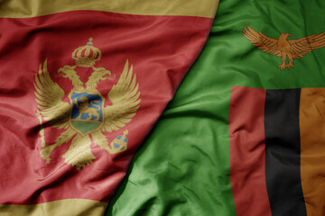 big waving national colorful flag of zambia and national flag of montenegro .