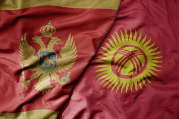 big waving national colorful flag of kyrgyzstan and national flag of montenegro .