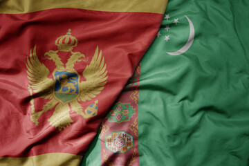 big waving national colorful flag of turkmenistan and national flag of montenegro .