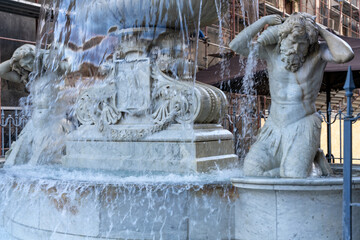 A fountain with statues of men and women