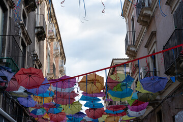 A row of colorful umbrellas hanging from the ceiling