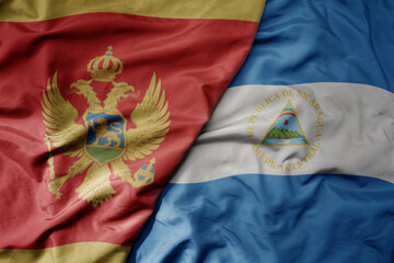 big waving national colorful flag of nicaragua and national flag of montenegro .