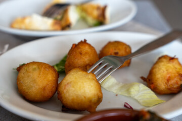 A plate of fried food with a fork on it