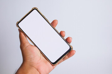 a cellphone held with a white screen on a white background