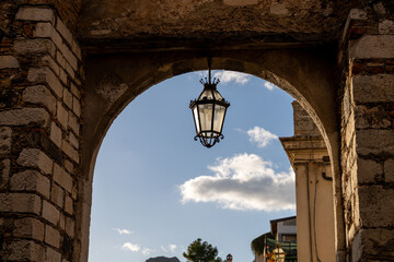 A lamp hanging from a stone archway