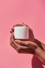 photography of skincare product blank in hands on color background
