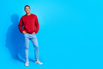 Full size portrait of positive minded young man put arms pockets look interested empty space...