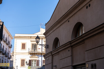 A building with a lamp on the roof and a blue sky in the background