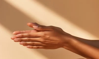 Foto op Canvas Closeup of female hand on orange background. Skin care, beauty procedure © TheoTheWizard