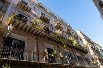 A balcony with potted plants and a view of the sky