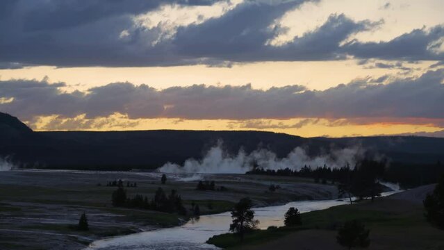 shot of mammatus clouds over geyser against sky during sunset - Yellowstone National Park, Wyoming. 