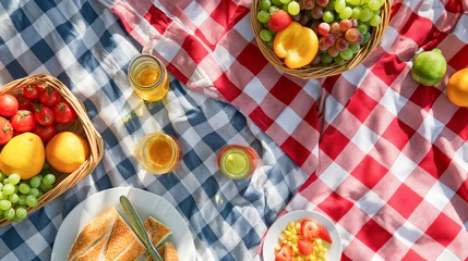 Selbstklebende Fototapeten A picnic blanket with a red and white checkered pattern, featuring fruits in baskets, sandwiches on plates, glasses of juice, and fruit © Ratthamond