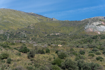 Fototapeta na wymiar A mountain range with a lush green hillside