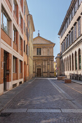 Fototapeta na wymiar A Street in Parma and in the Background the deconsecrated Renaissance Church of San Marcellino, Italy