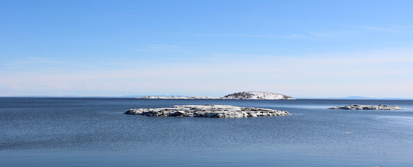 Snowy island on the St Lawrence River in Ragueneau, Quebec