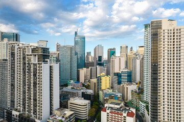 Fototapeta na wymiar Makati, Philippines - Aerial shot of Makati's bustling skyline, showcasing a blend of mid-20th century and modern architecture and city vibes.