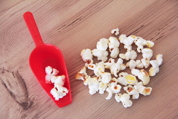 White delicious fried airy popcorn on a brown background