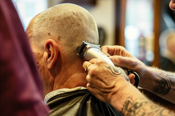 Close-up of a Professional Barber Giving a Haircut with Electric Clippers - obrazy, fototapety, plakaty