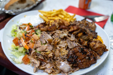 A plate of food with a variety of meats and vegetables