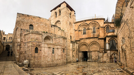 Fototapeta na wymiar Entrance to the Church of the Holy Sepulcher (Latin: Ecclesia Sancti Sepulchri) on a rainy day