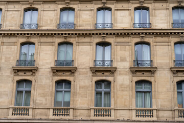 The building has a lot of windows and a balcony