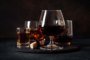 Strong alcohol drink. Cognac, whisky, rum, tequila at dark background.