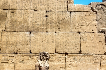 Hieroglyphics in Karnak temple with a faceless pharaoh in Luxor, Egypt