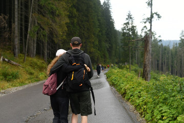 Poland, Zakopane, 17 August 2023 year . Tourists go to the mountains. A couple in love goes in an embrace.