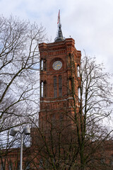 A tall red tower with a clock on it
