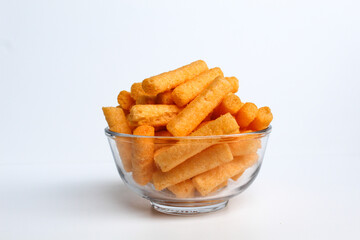 Stik Balado, crackers with savory powder coating. In transparent glass bowl. Isolated on white background