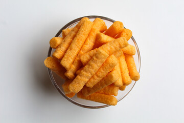 Stik Balado, crackers with savory powder coating. In transparent glass bowl. Isolated on white background , flat lay or top view