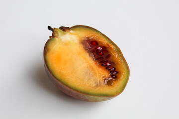 Halved Tamarillo or Solanum betaceum fruit. Isolated on white background