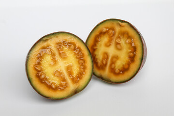 Sliced Tamarillo or Solanum betaceum fruit. Isolated on white background