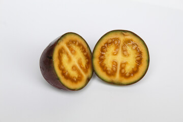Sliced Tamarillo or Solanum betaceum fruit. Isolated on white background