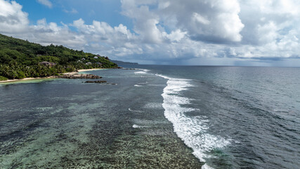 panoramic view from a drone of the sea bays and beaches on a sunny day of the Seychelles islands