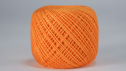 Orange skein of thread for embroidery on a white background