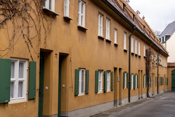Fototapeta na wymiar A row of brown buildings with green shutters
